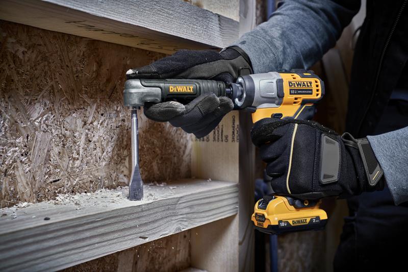 A person wearing black gloves uses a DEWALT cordless drill with a right angle attachment to drill into a piece of wood